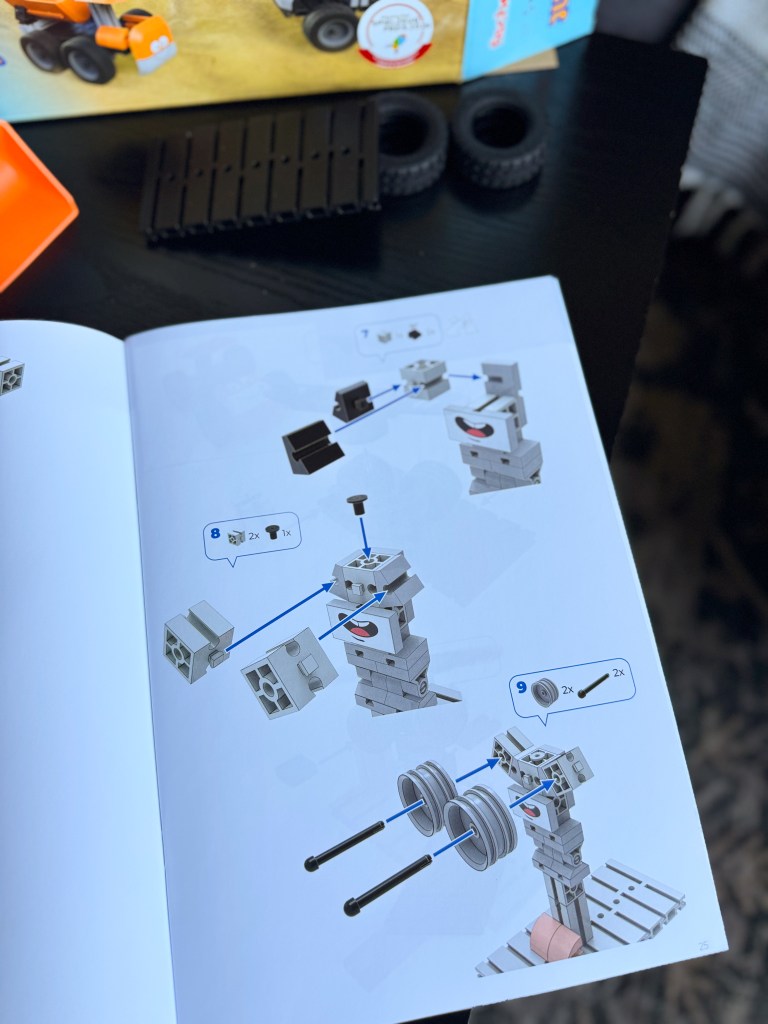 Instruction manual page showing steps to assemble a construction toy with labeled parts and assembly instructions.
