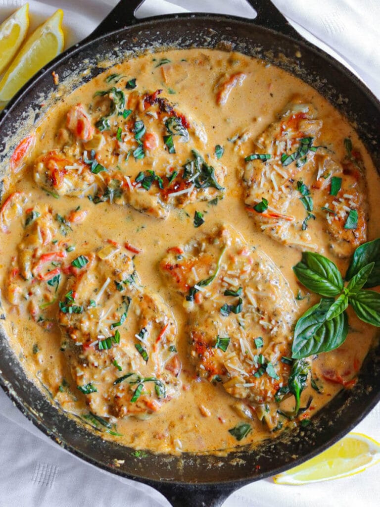 Creamy Tuscan chicken with spinach, sun-dried tomatoes, garlic, and a rich sauce for an easy weeknight dinner.