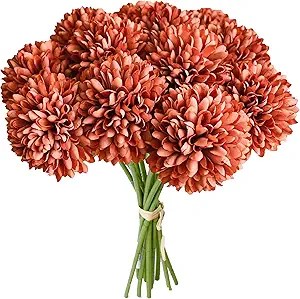 A bouquet of orange floral pom-poms tied with a natural twine, perfect for autumn decorating.