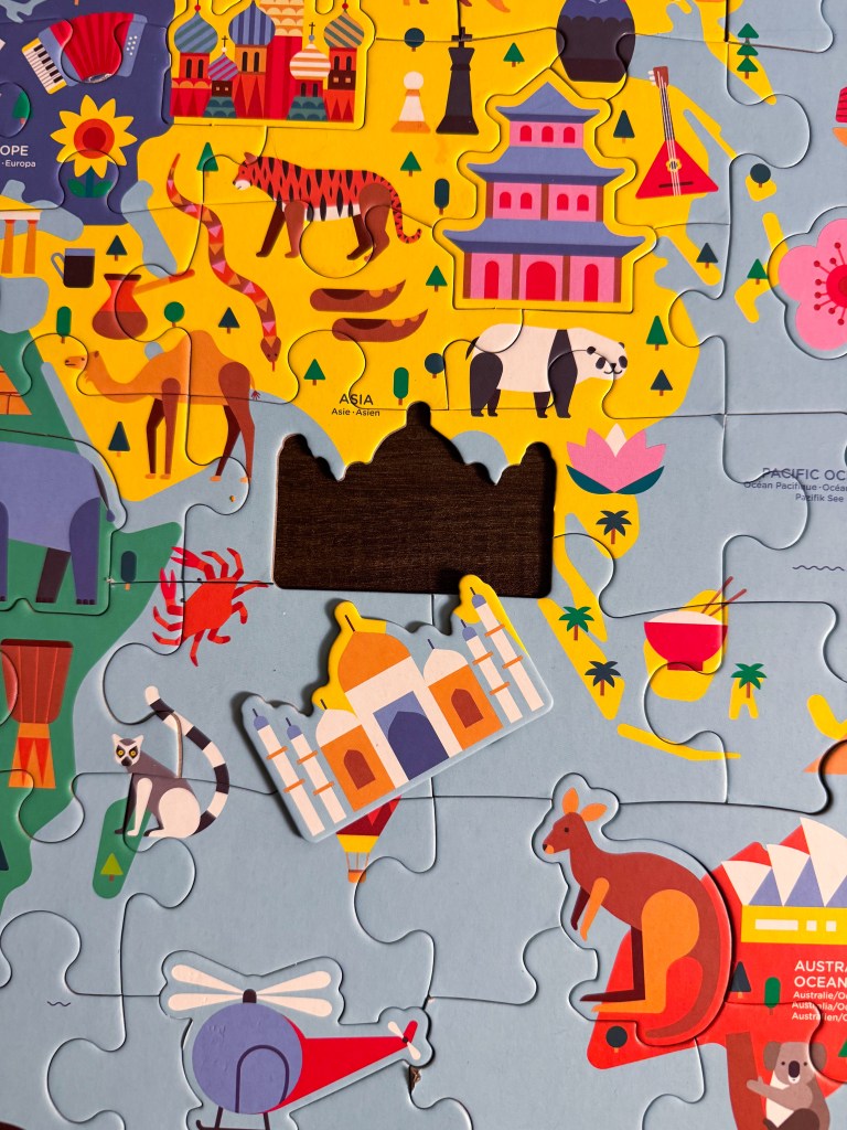 Taj Mahal landmark piece placed on the Asia section of the Map of the World Geography Puzzle.