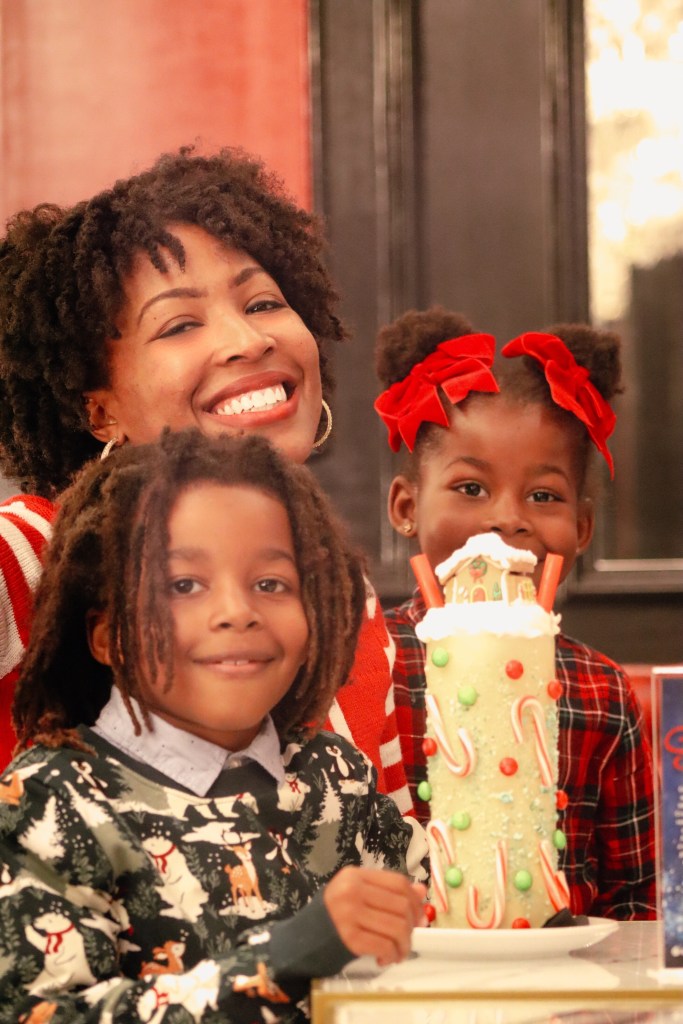 Family enjoying the festive gingerbread house Christmas milkshake at Sugar Factory Biloxi in Biloxi, Mississippi.