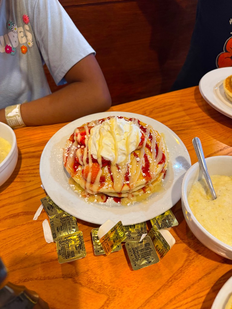 Strawberries and Cream Pancakes topped with strawberry sauce, sweet cream icing, and whipped cream at Flapjack's Pancake Cabin.