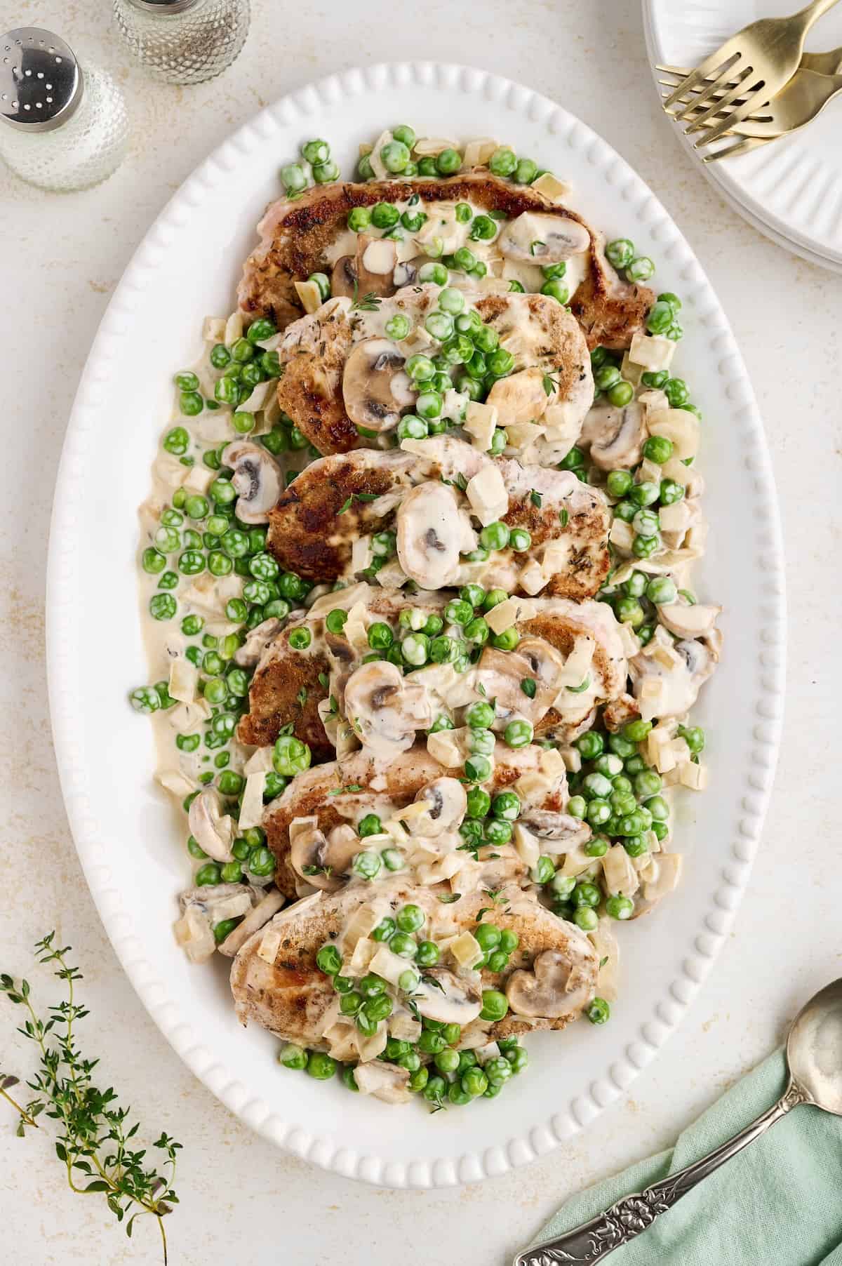 Pan-seared pork chops with mushroom pea Marsala sauce in a rich and creamy skillet sauce