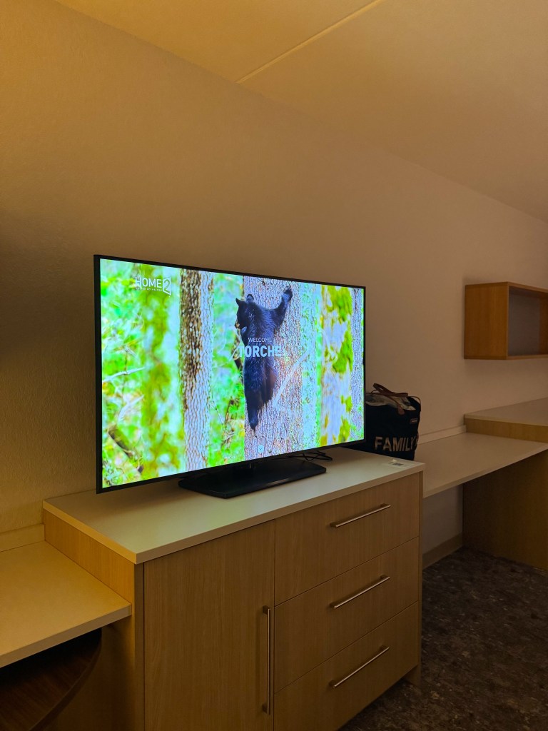 Family suite television, storage and desk area at Home2 Suites Pigeon Forge.