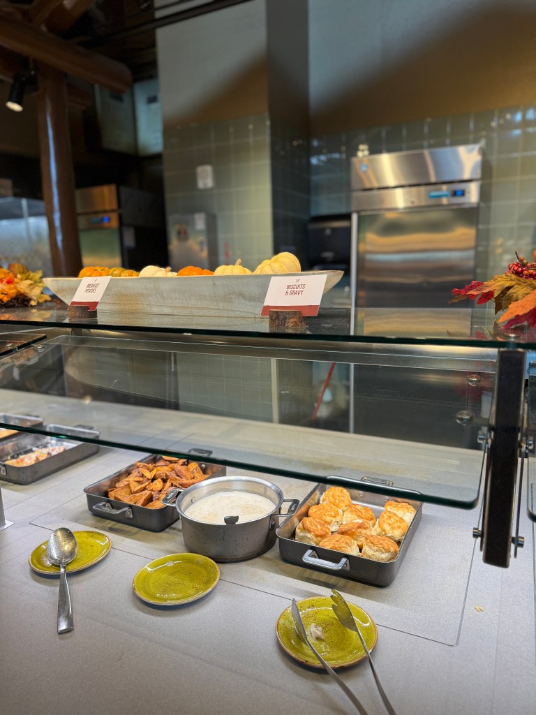 Breakfast buffet display featuring biscuits and gravy, roasted potatoes, and small pumpkins at Great Wolf Lodge in Grapevine, TX. 