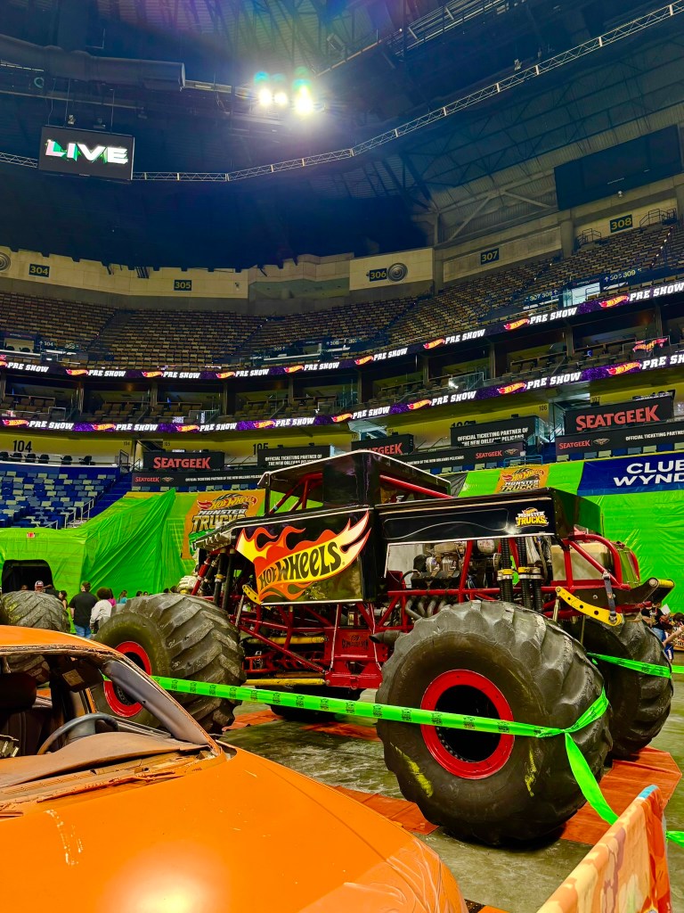 Bone Shaker monster truck with a black body, flaming skull design and red frame.