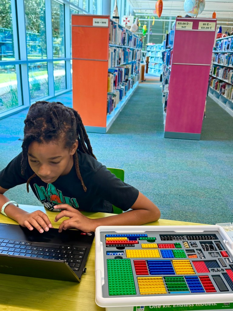 Student working on an advanced iBrick STEM build with a motorized mechanism