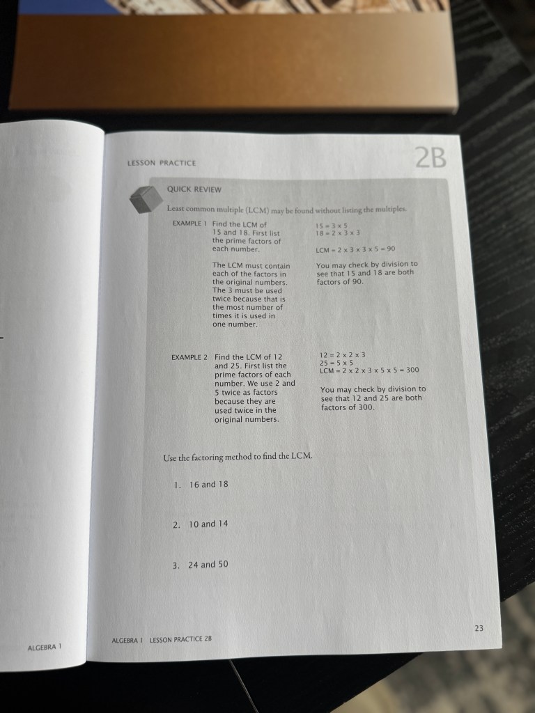 A close-up view of a Math-U-See Algebra 1 workbook page featuring a quick review section on least common multiples (LCM) with examples and practice problems.
