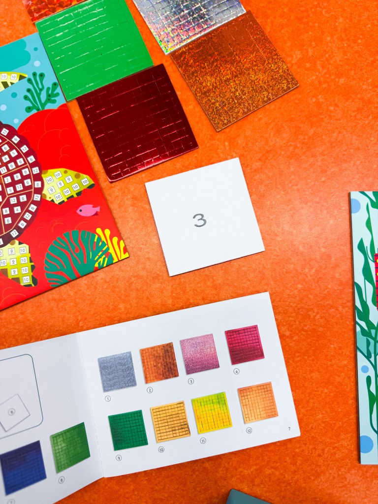 Instruction guide showing numbered mosaic colors for the Djeco Caribbean Mosaics activity.