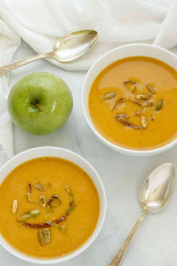 Velvety butternut squash apple soup topped with toasted pumpkin seeds