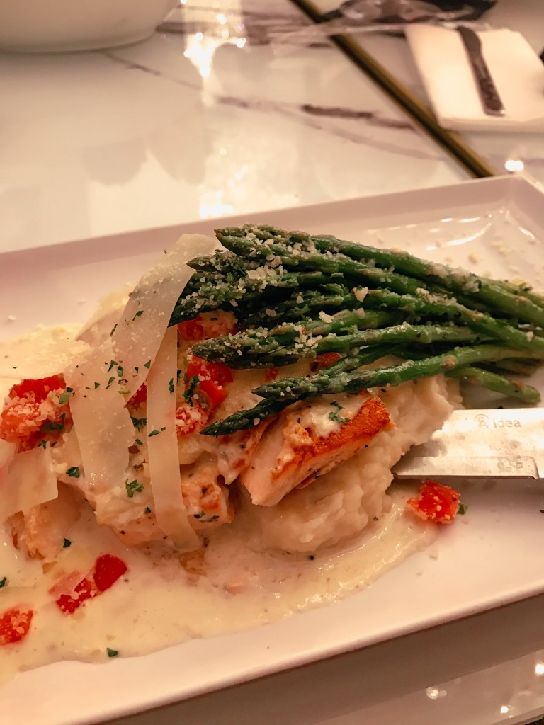 Grilled salmon served with creamy mashed potatoes and fresh asparagus at Sugar Factory Biloxi during the holiday season.