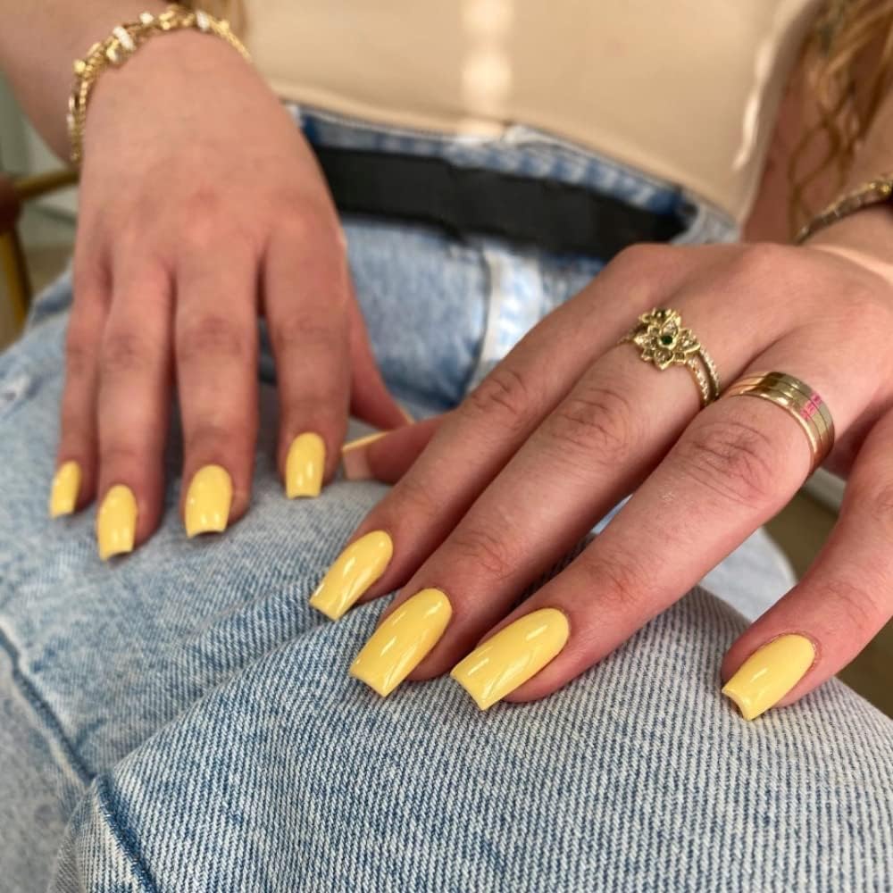 Glossy simple butter yellow coffin nails with soft pastel yellow polish and minimalist clean manicure aesthetic