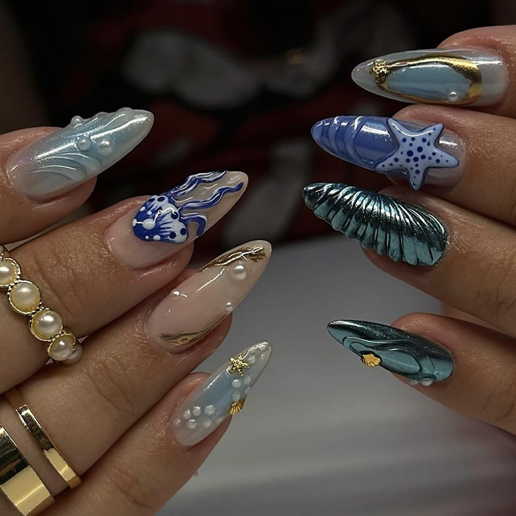Elegant blue sea shell nails with chrome accents, starfish art, and classy ocean-inspired summer manicure
