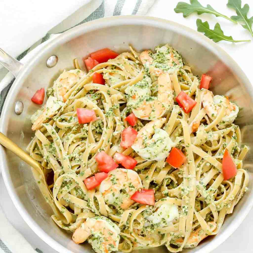 Fettuccine pasta with shrimp and arugula pesto cream sauce for a fresh summer seafood dinner.