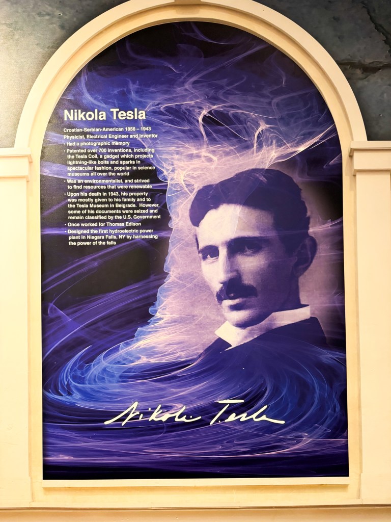 A portrait of Nikola Tesla, featuring a brief biography highlighting his achievements as a physicist, electrical engineer, and inventor, with a colorful, swirling background.