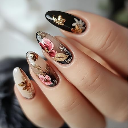 Close-up view of decorative fall-themed nails featuring floral designs in pink, brown, and gold accents on a mix of nude and black backgrounds.