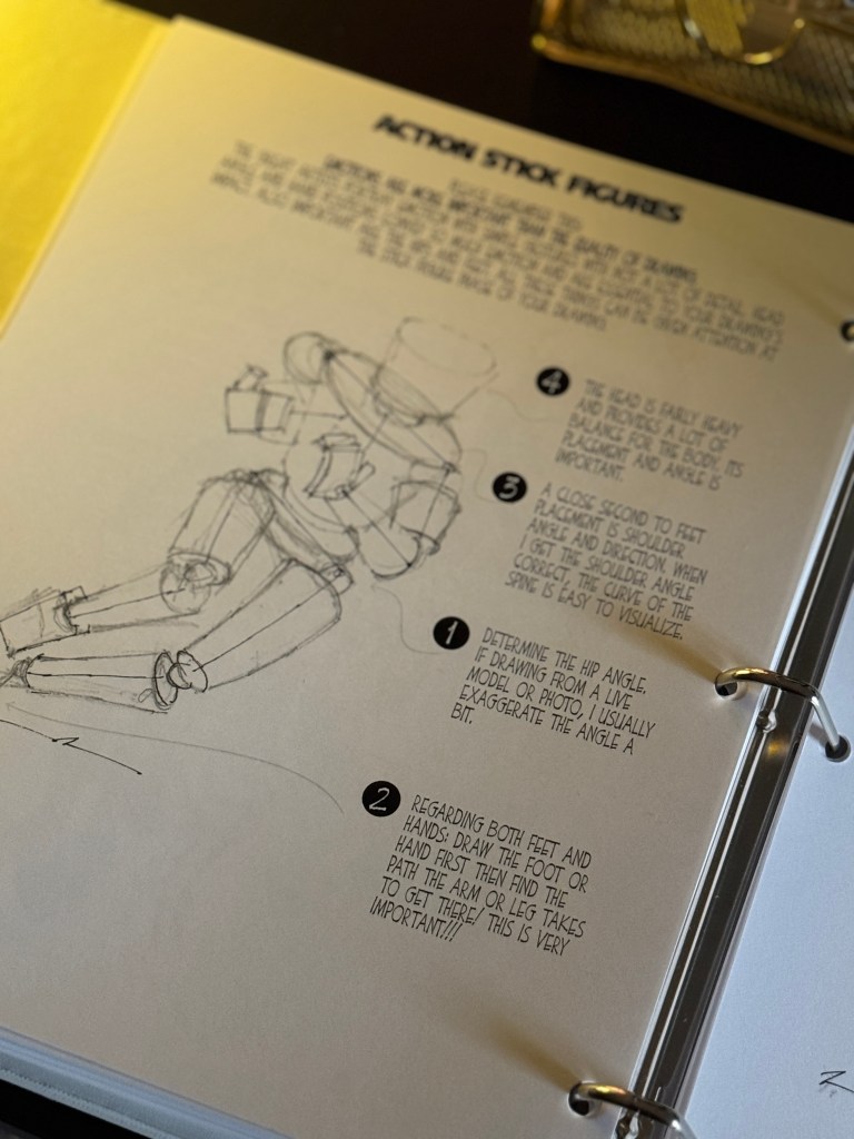 Open binder page showing instructions for drawing action stick figures, featuring steps with sketches and tips.