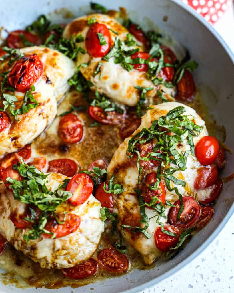 Caprese chicken with fresh mozzarella, tomatoes, basil, and balsamic glaze for an easy summer dinner.