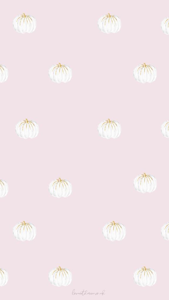 A light pink wallpaper featuring a repeating pattern of white pumpkins with golden stems.