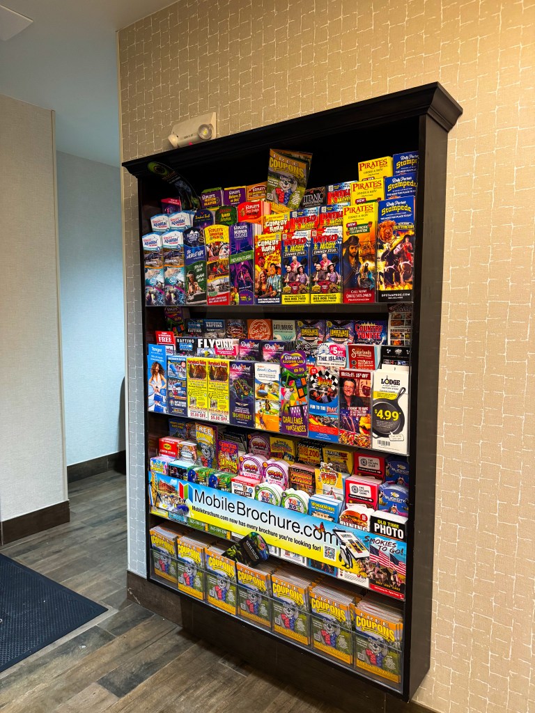 Display of Pigeon Forge attraction brochures and coupons inside Home2 Suites.