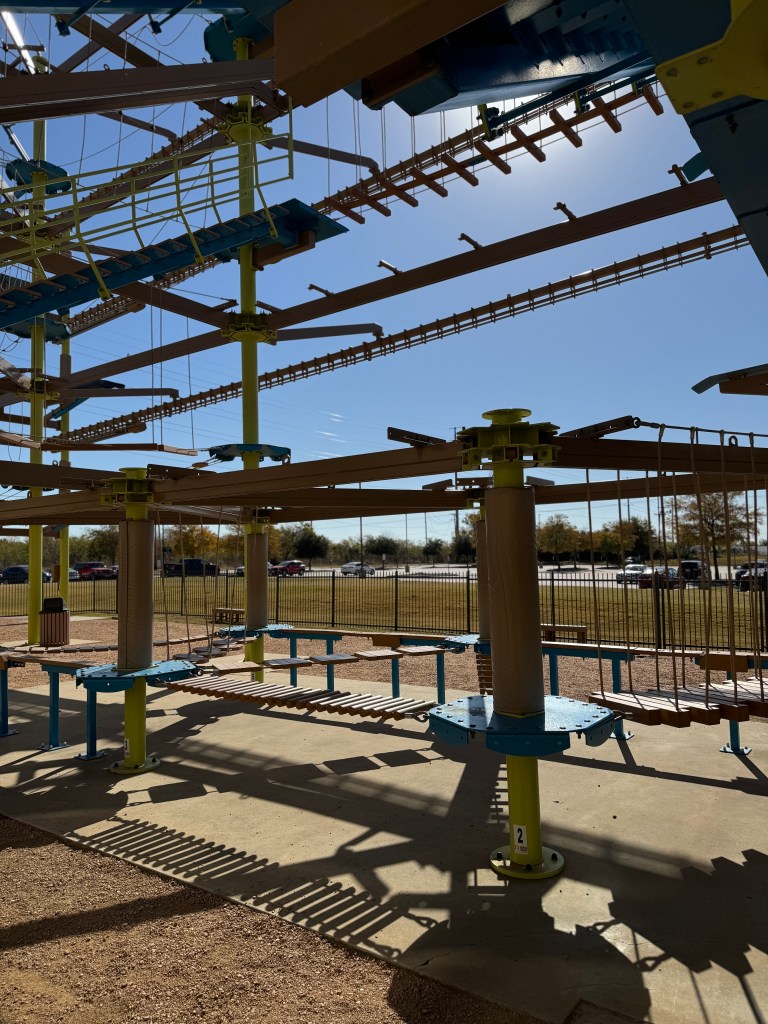 Lower section of the outdoor ropes course at Great Wolf Lodge Grapevine featuring suspended bridges and balance obstacles.