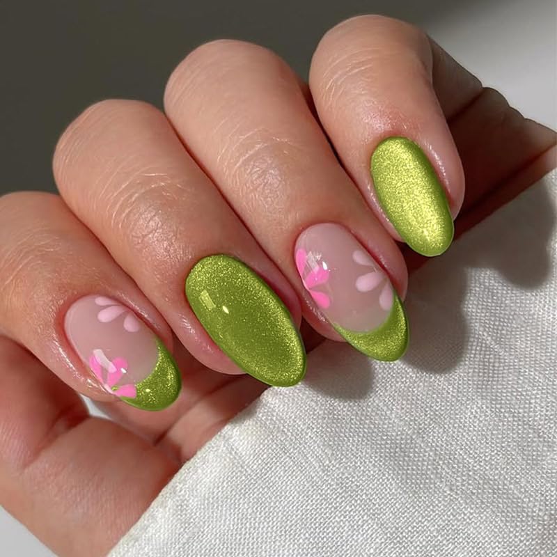 Close-up of manicured nails featuring a mix of green polish and light pink with floral designs.