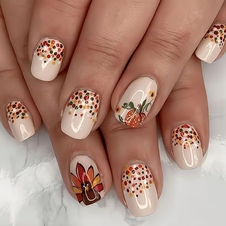 A close-up view of hands showcasing whimsical Thanksgiving nail art featuring colorful polka dots, tiny pumpkins, and a turkey design on a neutral background.