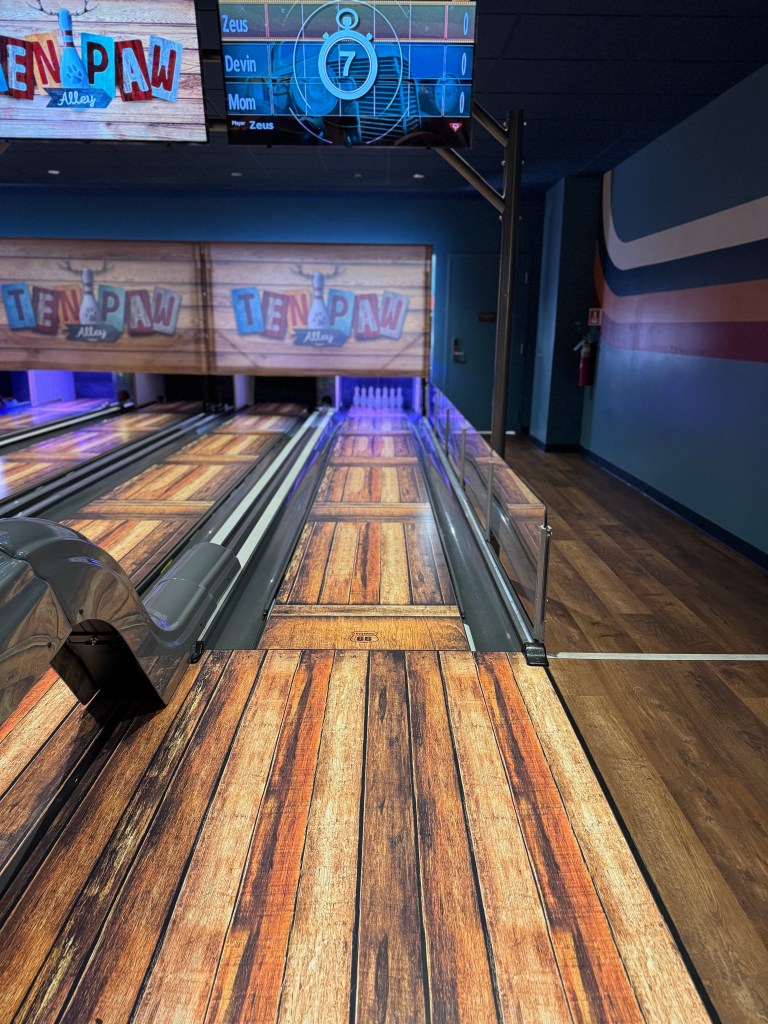 Ten Paw Alley mini bowling lane at Great Wolf Lodge Grapevine with pins set and the digital scoreboard overhead.