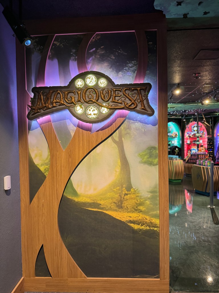 Signage for MagiQuest with a mystical forest background at Great Wolf Lodge.