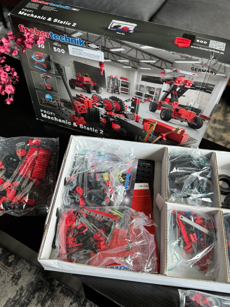 Image of the Fischer Technik STEM Kit box with various building pieces in open packaging, showcasing its contents and design.
