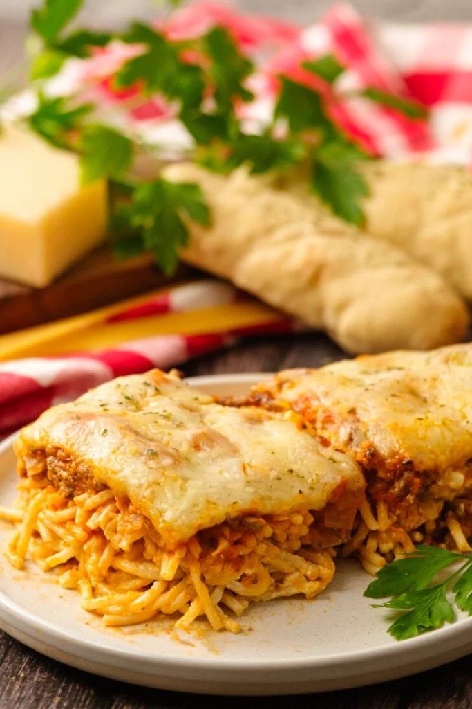 Baked spaghetti casserole with layers of pasta, meat sauce, and melted cheese