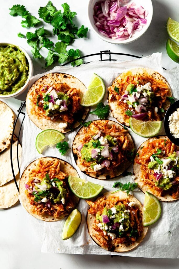 Chicken tinga tacos with shredded chicken in a smoky tomato sauce