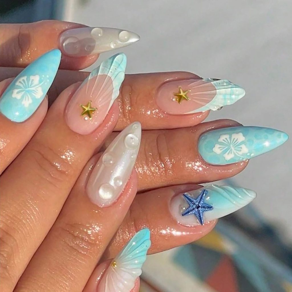 Tropical hibiscus ocean nails with turquoise French tips, floral nail art, and pearl beach-inspired accents