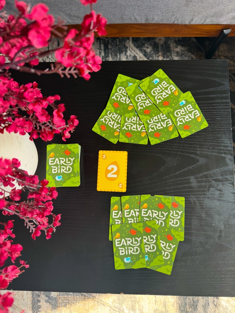 Early Bird card game being played with number cards, challenge cards, and the worm piece