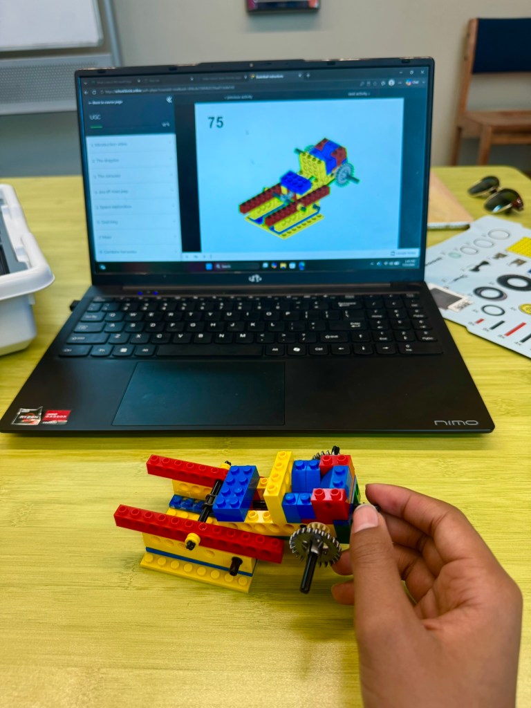 iBrick homeschool STEM kit with digital building lessons on a laptop