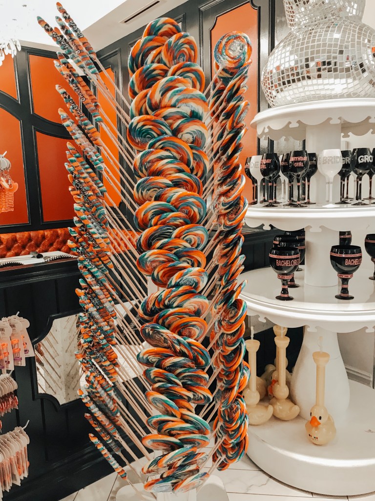 Oversized rainbow lollipops displayed inside the Sugar Factory Biloxi candy shop.