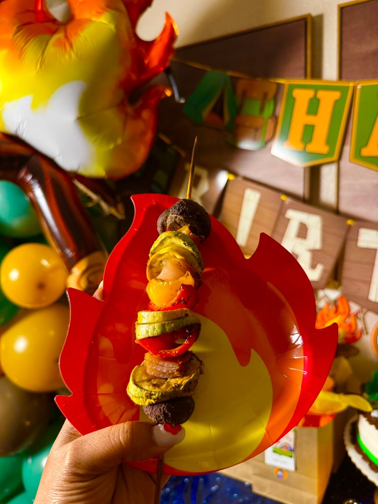 Veggie skewer on a campfire plate for a camping themed birthday party.
