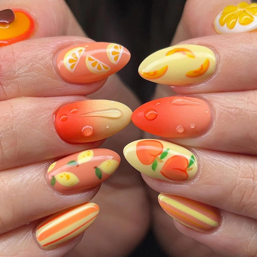 Almond nails with orange and lemon fruit nail art and gradient orange tones