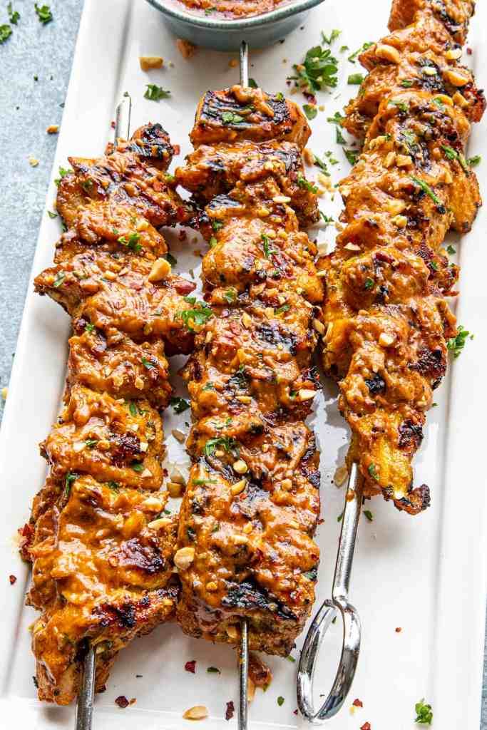 Chicken satay skewers with Thai-inspired marinade and peanut sauce for a flavorful summer dinner.