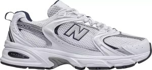 A pair of white New Balance sneakers featuring a mesh upper and cushioned sole, ideal for casual and sporty outfits.