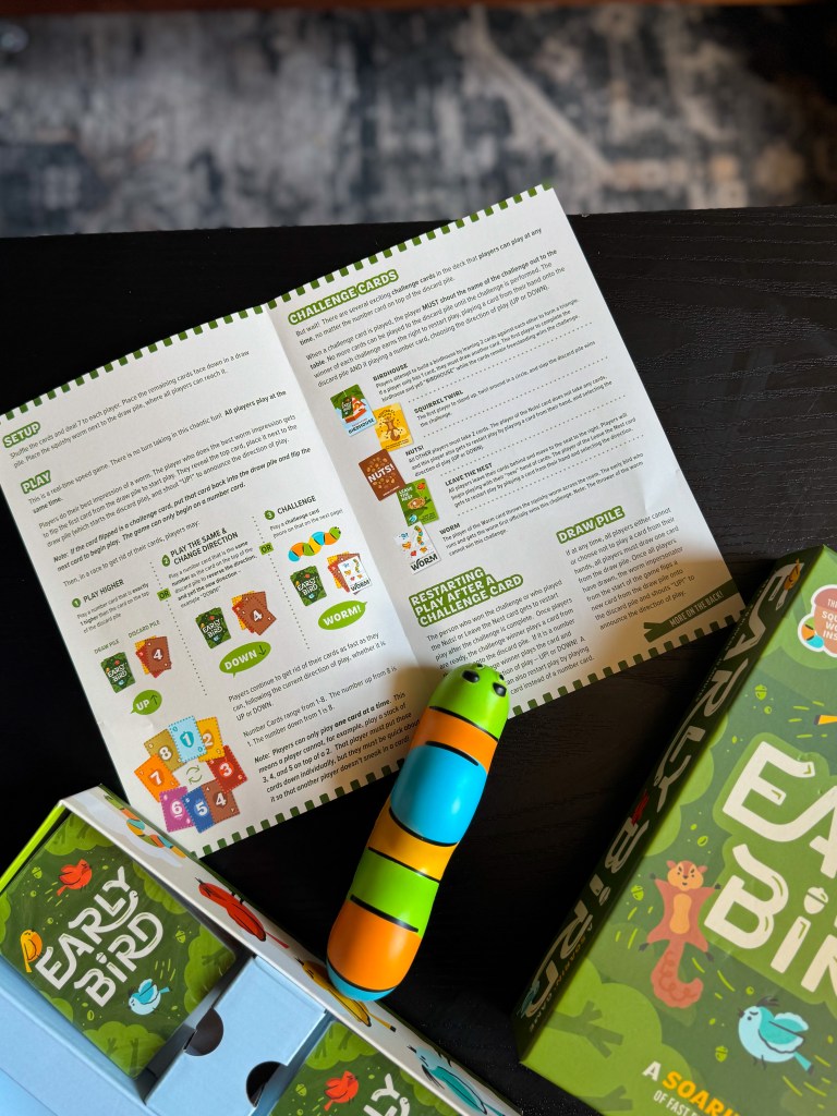 Early Bird game instructions displayed with cards, game box, and squishy worm piece