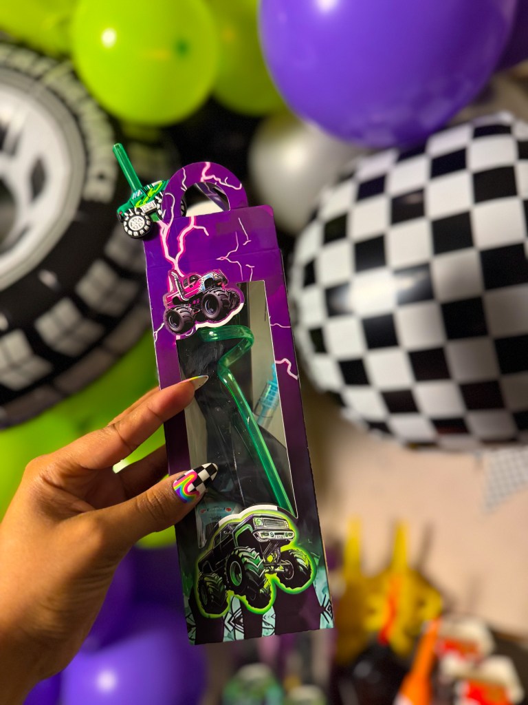 Monster Jam birthday party favor box with monster truck themed straw and racing decorations.