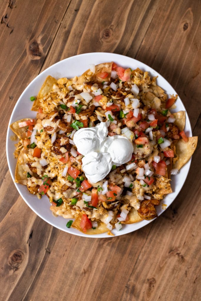 Cajun seafood nachos topped with shrimp, crab, catfish, and creamy cheese sauce for a fun summer dinner.