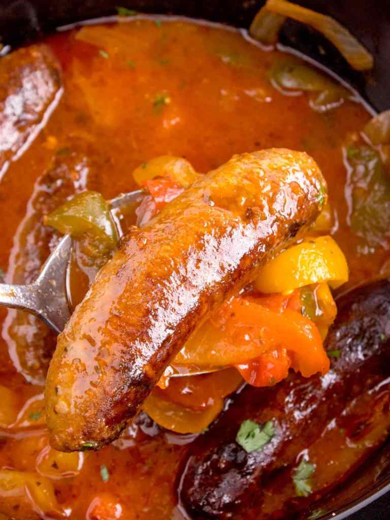 Slow cooker sausage and peppers with onions in a rich sauce for an easy family dinner.