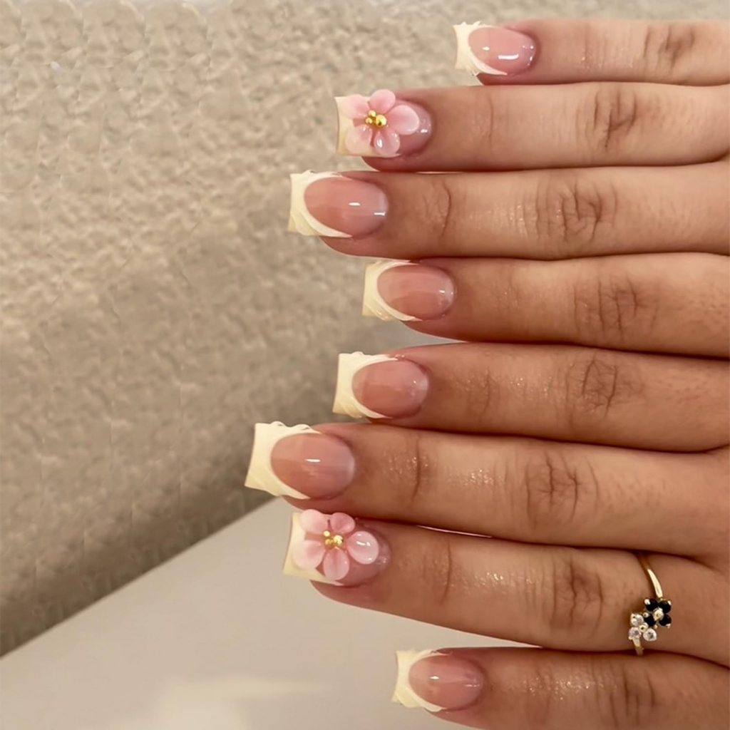 Butter yellow square nails with delicate floral accent nail art and glossy pastel yellow manicure design