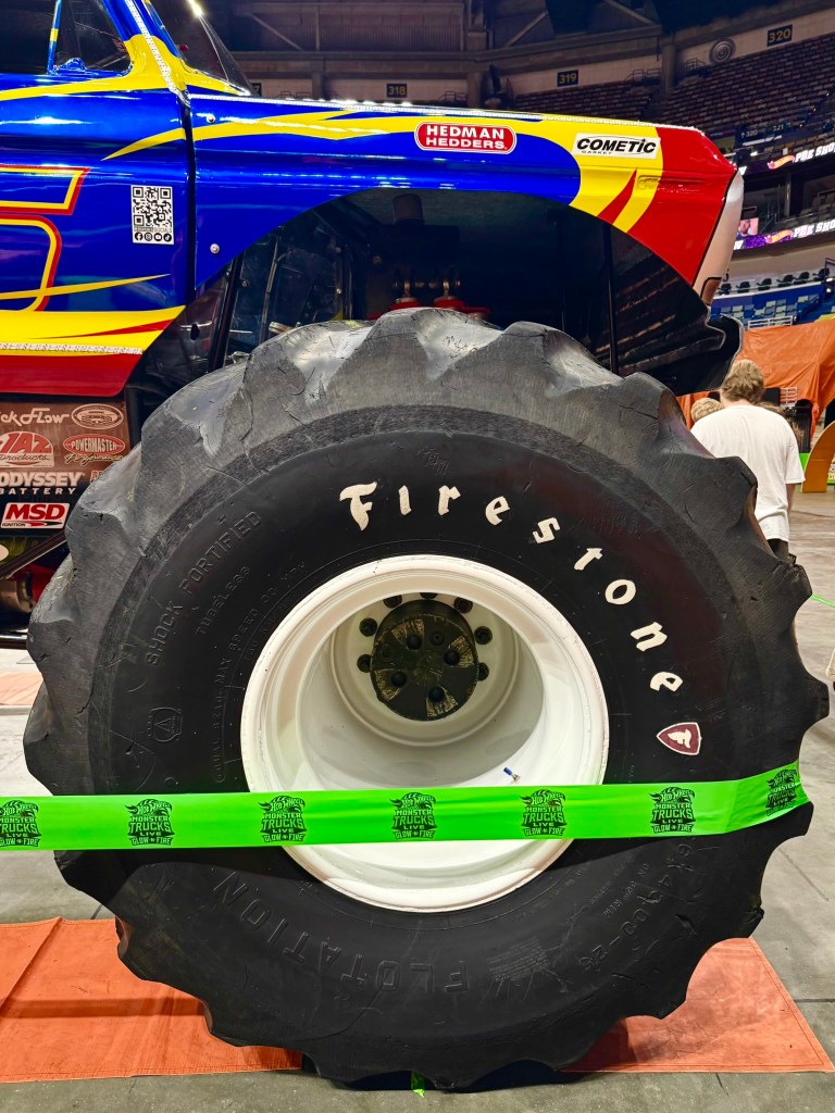 Close-up of a giant Firestone tire mounted on the Bigfoot monster truck.
