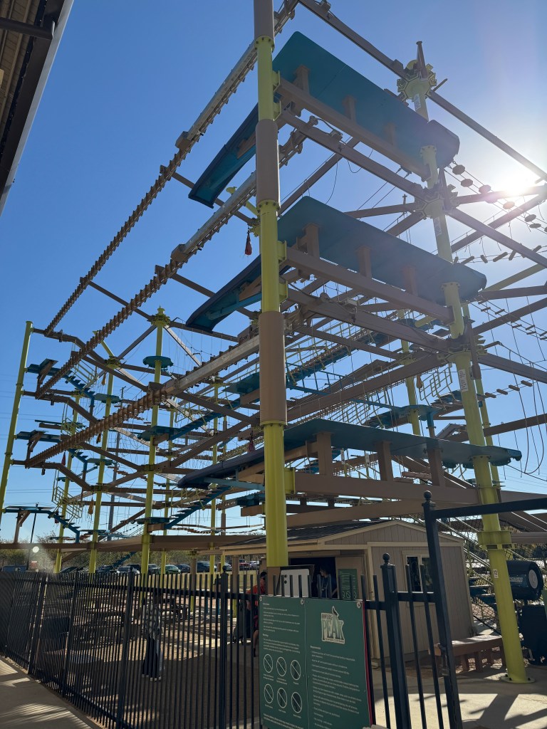 Full view of the multi-level outdoor ropes course at Great Wolf Lodge Grapevine with elevated obstacles and climbing platforms.