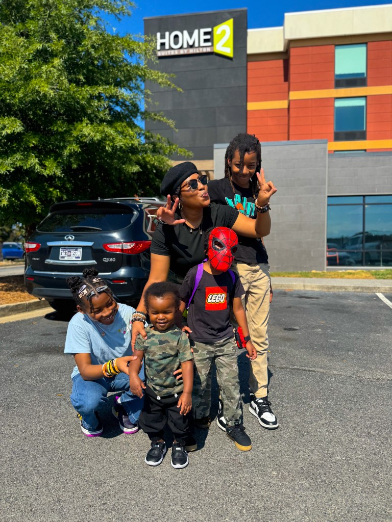 Mom and four children outside Home2 Suites by Hilton Pigeon Forge during a family trip.