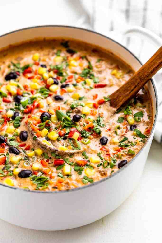 Cozy creamy taco soup topped with shredded cheese, sour cream, and fresh cilantro