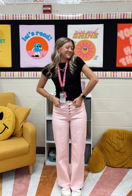 spring teacher outfit with black top and pink pants